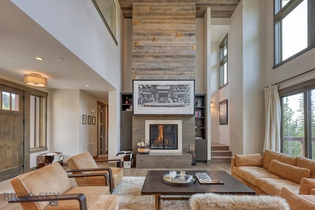 102 Outlook Trl, Big Sky, MT 59716 - living area featuring a high ceiling, a fireplace, wood finished floors, stairway, and built in shelves