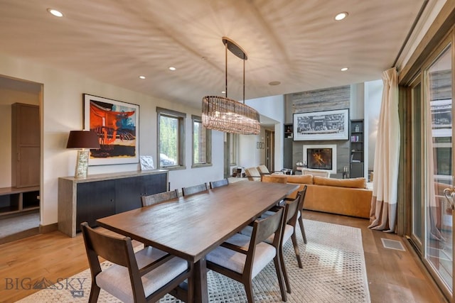 102 Outlook Trl, Big Sky, MT 59716 - dining area with light wood finished floors, a fireplace, and recessed lighting
