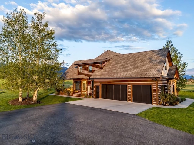 306 Glenbrook Ln, Belgrade, MT 59714 - log-style house featuring asphalt driveway, a front lawn, and an attached garage