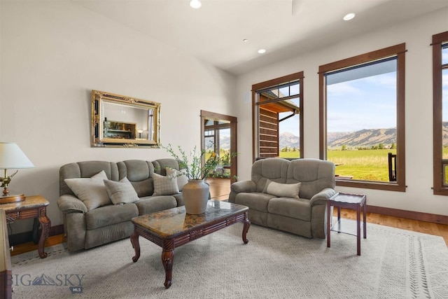 306 Glenbrook Ln, Belgrade, MT 59714 - living room featuring a mountain view, healthy amount of natural light, wood finished floors, recessed lighting, and baseboards