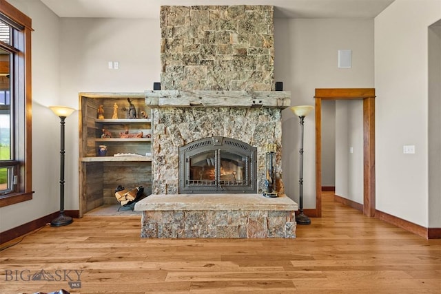 306 Glenbrook Ln, Belgrade, MT 59714 - detailed view of baseboards, wood finished floors, and a stone fireplace