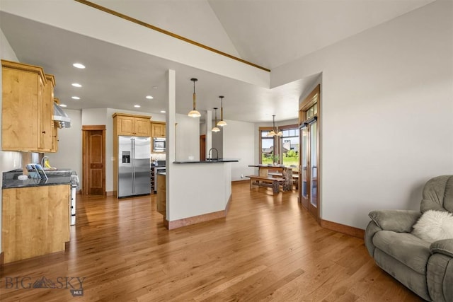 306 Glenbrook Ln, Belgrade, MT 59714 - kitchen featuring stainless steel appliances, open floor plan, dark countertops, light wood finished floors, and recessed lighting