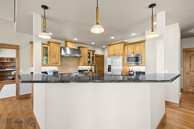 306 Glenbrook Ln, Belgrade, MT 59714 - kitchen featuring stainless steel appliances, extractor fan, light wood-style flooring, recessed lighting, and decorative backsplash