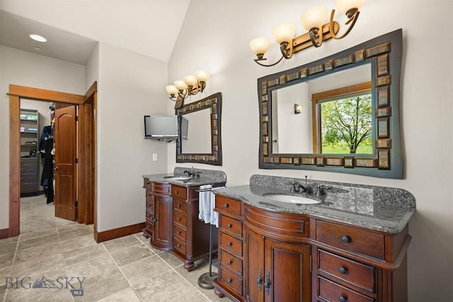 306 Glenbrook Ln, Belgrade, MT 59714 - full bath with two vanities, baseboards, and vaulted ceiling