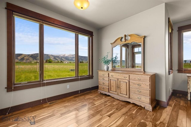 306 Glenbrook Ln, Belgrade, MT 59714 - bedroom featuring light wood-style flooring, a mountain view, and baseboards
