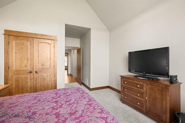 306 Glenbrook Ln, Belgrade, MT 59714 - bedroom with lofted ceiling, light carpet, and baseboards