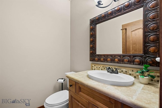 306 Glenbrook Ln, Belgrade, MT 59714 - bathroom featuring tasteful backsplash, toilet, and vanity