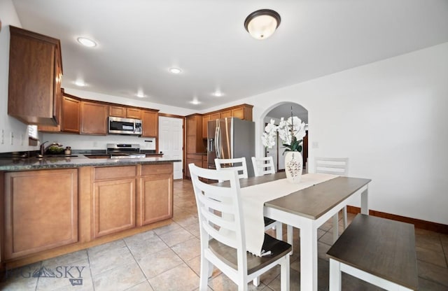 4068 Opal St, Bozeman, MT 59718 - dining area with arched walkways, recessed lighting, light tile patterned flooring, and baseboards