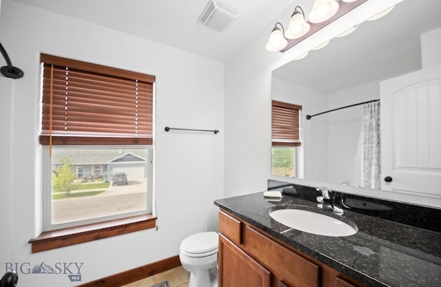 4068 Opal St, Bozeman, MT 59718 - full bathroom featuring toilet, vanity, a shower with shower curtain, and baseboards