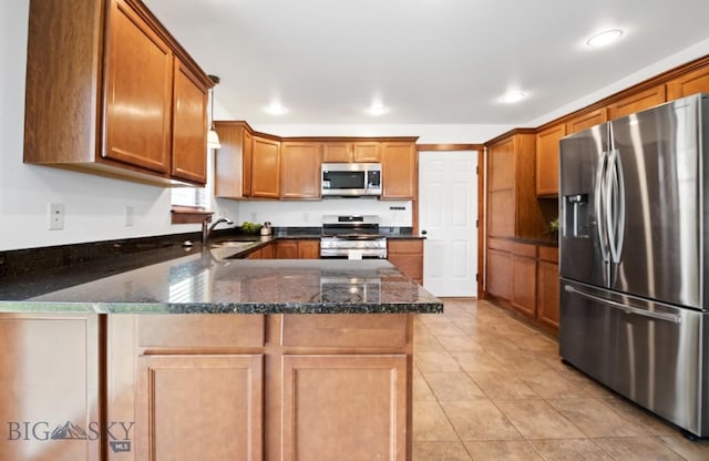4068 Opal St, Bozeman, MT 59718 - kitchen featuring stainless steel appliances, a peninsula, brown cabinets, recessed lighting, and light tile patterned floors