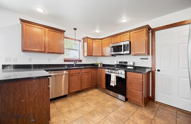 4068 Opal St, Bozeman, MT 59718 - kitchen with appliances with stainless steel finishes, a sink, brown cabinetry, and recessed lighting
