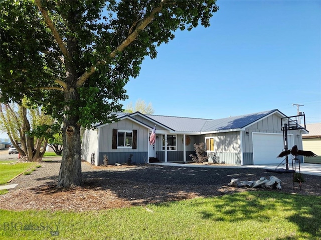108 E 9th Ave, Twin Bridges, MT 59754 - ranch-style home with a garage, board and batten siding, metal roof, and a front yard