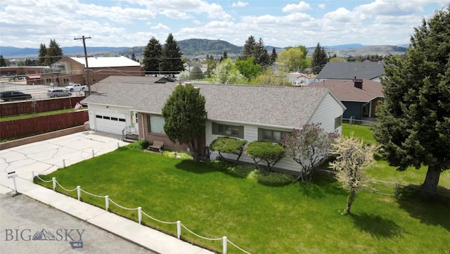 2301 Banks Ave, Butte, MT 59701 - ranch-style home with concrete driveway, a mountain view, a residential view, and an attached garage