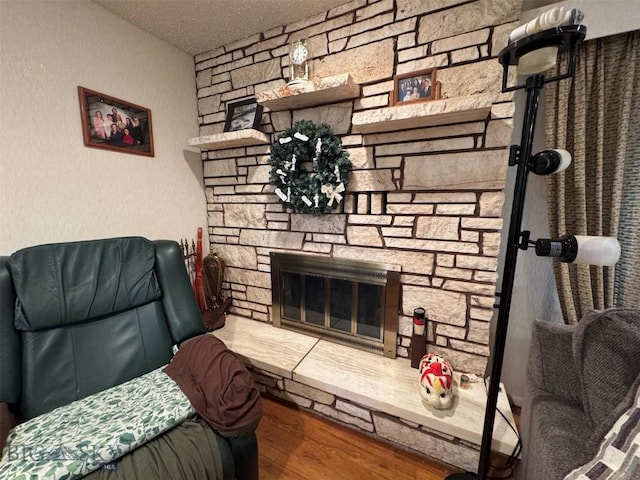 2301 Banks Ave, Butte, MT 59701 - living room with a stone fireplace, wood finished floors, and a textured ceiling