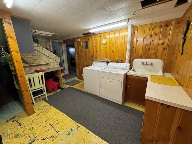 2301 Banks Ave, Butte, MT 59701 - laundry room with washing machine and clothes dryer, wood walls, and cabinet space