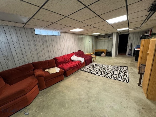 2301 Banks Ave, Butte, MT 59701 - living area featuring concrete floors, wooden walls, and a paneled ceiling
