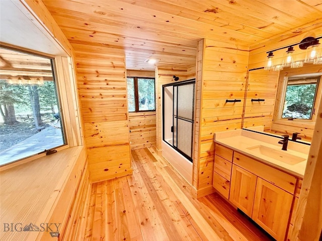 14 Ken Dan, Mcleod, MT 59052 - full bathroom with wooden ceiling, wooden walls, vanity, wood-type flooring, and enclosed tub / shower combo