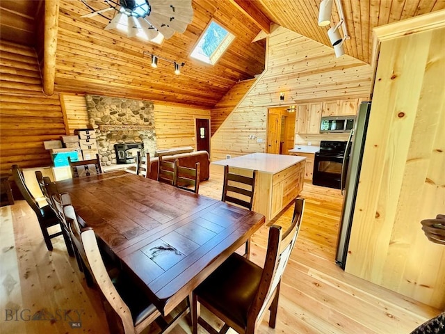 14 Ken Dan, Mcleod, MT 59052 - dining space with a skylight, track lighting, light wood-style floors, wooden ceiling with exposed beams, and wood walls