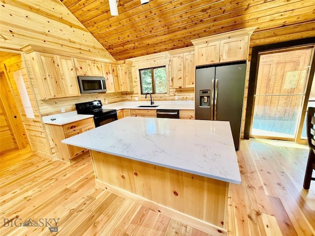 14 Ken Dan, Mcleod, MT 59052 - kitchen with appliances with stainless steel finishes, light brown cabinets, a sink, light wood-style flooring, and wooden walls