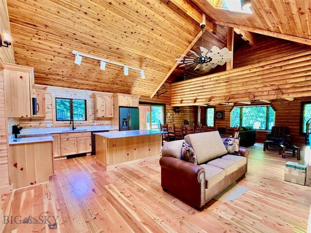 14 Ken Dan, Mcleod, MT 59052 - living room featuring log walls, high vaulted ceiling, wooden ceiling with exposed beams, light wood-style flooring, and track lighting