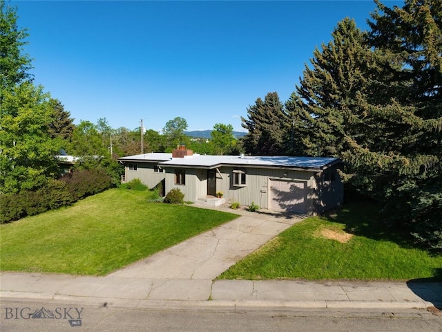 1524 S Grand, Bozeman, MT 59715 - mid-century home featuring an attached garage, a front yard, driveway, and a chimney