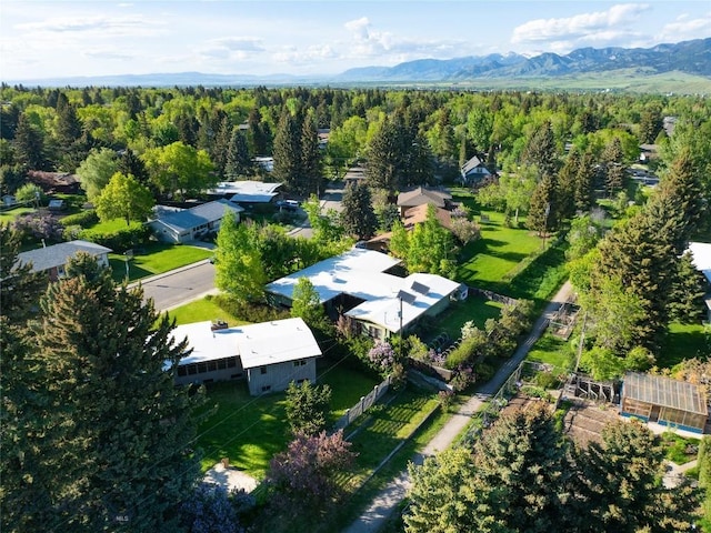 1524 S Grand, Bozeman, MT 59715 - aerial view of property and surrounding area featuring a heavily wooded area and a mountain backdrop
