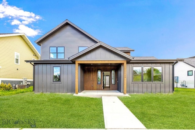4149 Annie St, Bozeman, MT 59718 - rear view of property with board and batten siding and a lawn