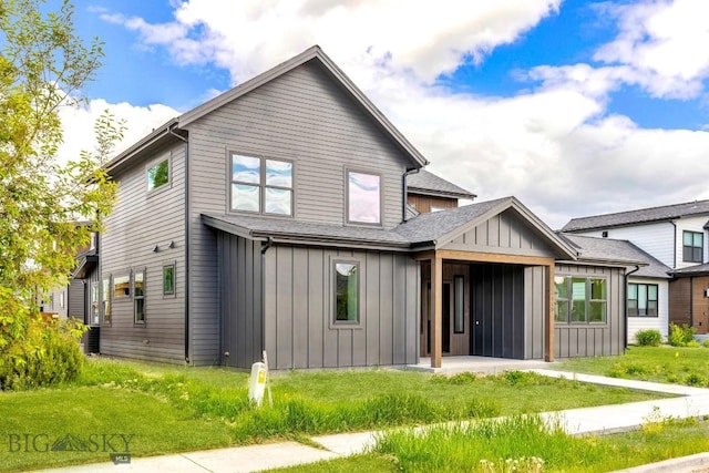 4149 Annie St, Bozeman, MT 59718 - view of front facade with board and batten siding, a front yard, and roof with shingles