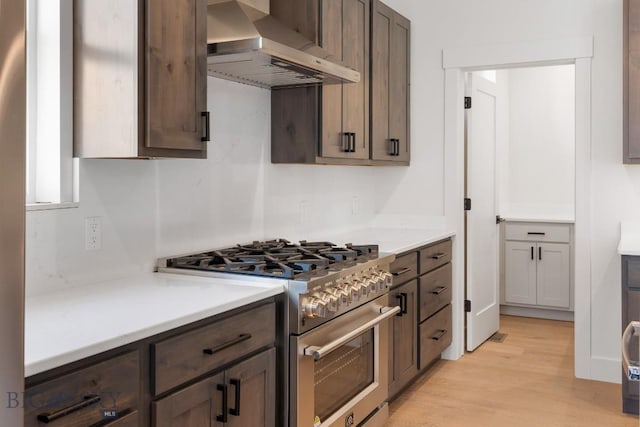 4149 Annie St, Bozeman, MT 59718 - kitchen featuring high end stove, range hood, light wood-style floors, and light countertops