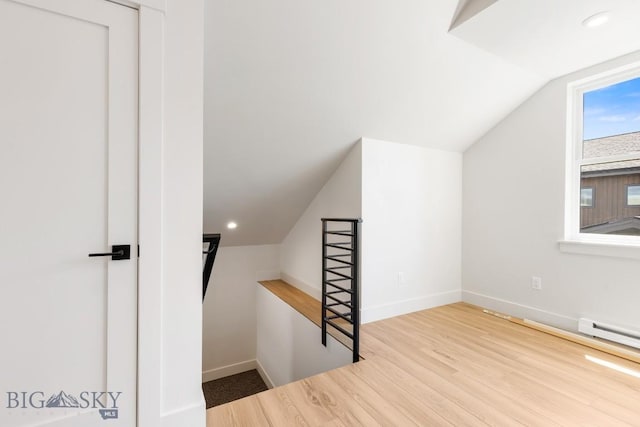 4149 Annie St, Bozeman, MT 59718 - bonus room featuring vaulted ceiling, wood finished floors, baseboards, and a baseboard radiator