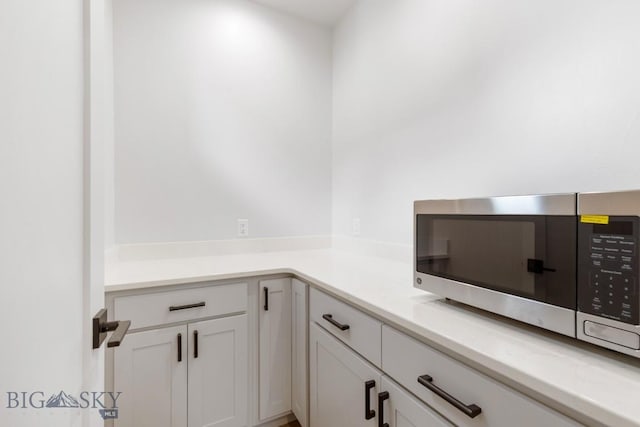 4149 Annie St, Bozeman, MT 59718 - kitchen with stainless steel microwave, white cabinets, and light countertops