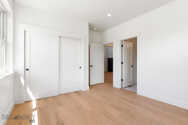 4149 Annie St, Bozeman, MT 59718 - unfurnished bedroom with light wood-style flooring, baseboards, a closet, and recessed lighting