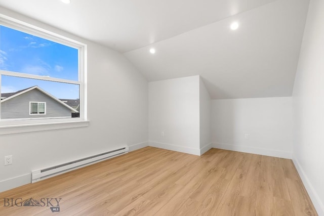 4149 Annie St, Bozeman, MT 59718 - additional living space with a baseboard radiator, lofted ceiling, wood finished floors, baseboards, and recessed lighting
