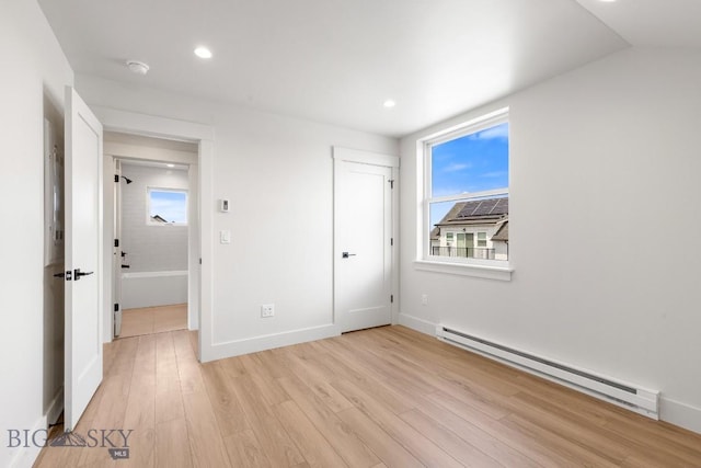 4149 Annie St, Bozeman, MT 59718 - unfurnished bedroom featuring a baseboard heating unit, light wood-type flooring, recessed lighting, and baseboards