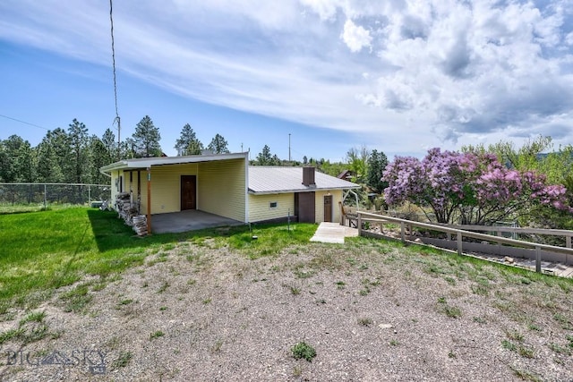 3456 Wave, Helena, MT 59602 - rear view of house with a patio and a carport