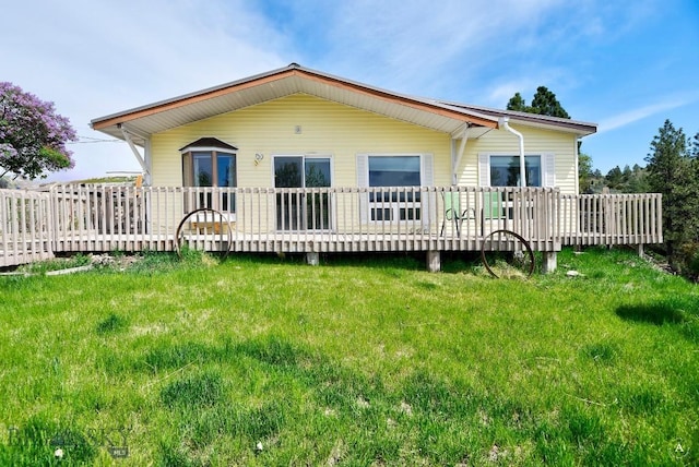 3456 Wave, Helena, MT 59602 - rear view of house featuring a wooden deck and a lawn