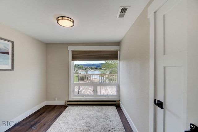 3456 Wave, Helena, MT 59602 - empty room with baseboard heating, dark wood-style flooring, baseboards, and a water view