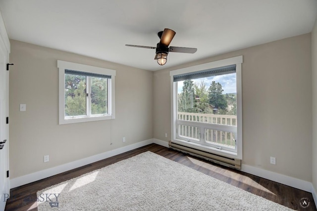 3456 Wave, Helena, MT 59602 - empty room with a baseboard radiator, baseboards, dark wood-type flooring, and a ceiling fan