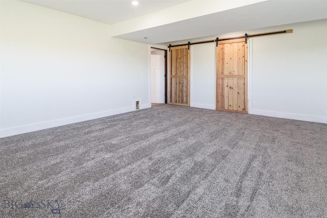 9 Murray Ln, Three Forks, MT 59721 - unfurnished bedroom with a barn door and carpet floors