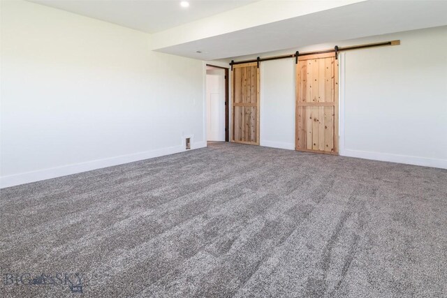 9 Murray Ln, Three Forks, MT 59721 - unfurnished bedroom with a barn door and carpet flooring