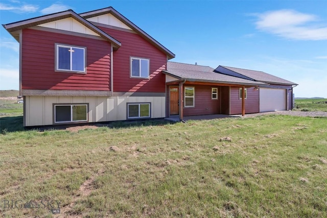 9 Murray Ln, Three Forks, MT 59721 - back of house with an attached garage, a lawn, and board and batten siding