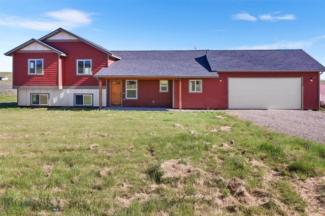 9 Murray Ln, Three Forks, MT 59721 - view of front of home with gravel driveway, an attached garage, a front yard, and roof with shingles
