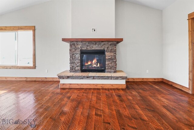 9 Murray Ln, Three Forks, MT 59721 - unfurnished living room with wood finished floors, a stone fireplace, and lofted ceiling