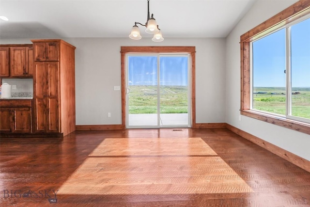 9 Murray Ln, Three Forks, MT 59721 - unfurnished dining area with dark wood-style floors and a chandelier