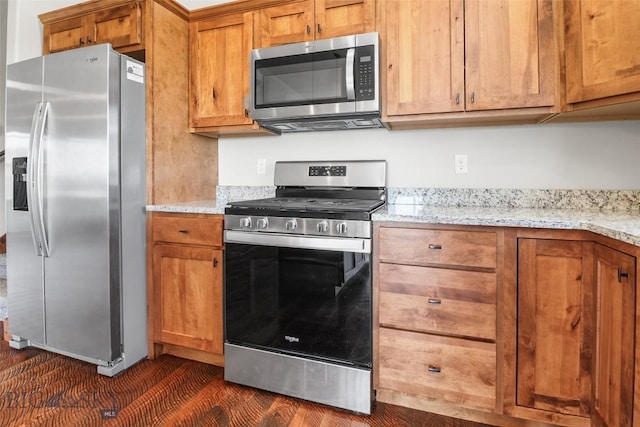 9 Murray Ln, Three Forks, MT 59721 - kitchen featuring stainless steel appliances, brown cabinetry, and light stone counters