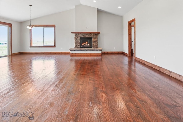 9 Murray Ln, Three Forks, MT 59721 - unfurnished living room with wood finished floors, vaulted ceiling, a stone fireplace, and recessed lighting