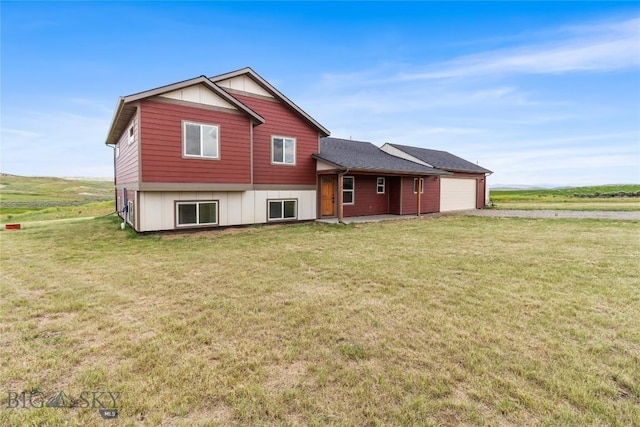 9 Murray Ln, Three Forks, MT 59721 - rear view of house with a garage, driveway, a yard, and board and batten siding
