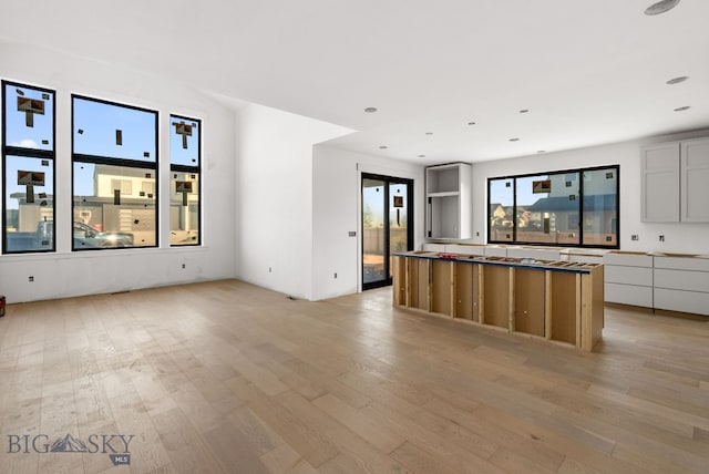 286 Lion Peak, Bozeman, MT 59718 - kitchen with light wood finished floors, a kitchen island, and open floor plan