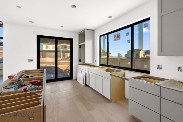 286 Lion Peak, Bozeman, MT 59718 - kitchen with light wood-style flooring, white cabinetry, and recessed lighting