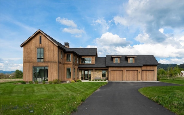 529 Clancy Way, Bozeman, MT 59718 - view of front of home with a front yard, asphalt driveway, a chimney, a shingled roof, and a mountain view